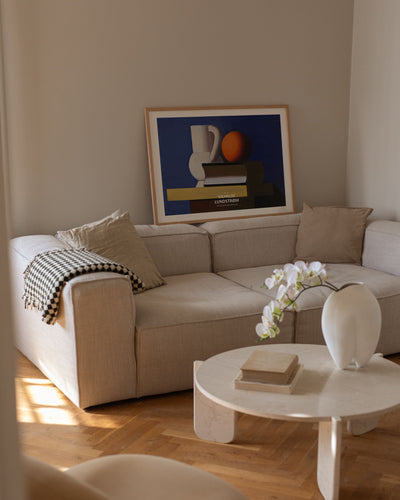 Arrangement with white jug, orange and book